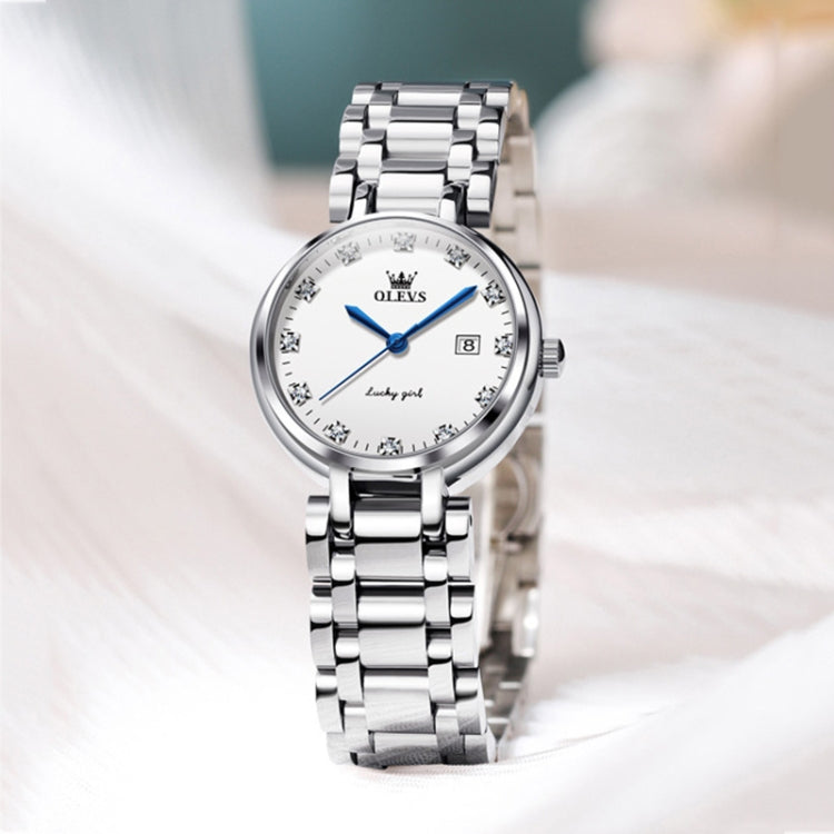 OLEVS ladies quartz watch on wrist, white dial with blue hands and steel bracelet