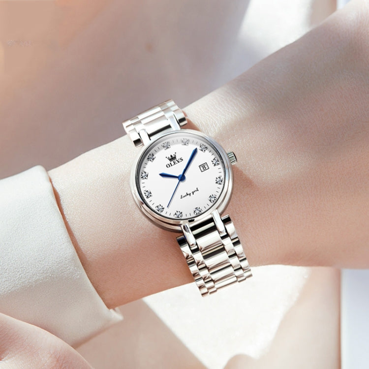 OLEVS ladies quartz watch on wrist, white dial with blue hands and silver steel links