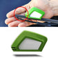 Green-and-white restorer held against windshield wiper blade for cleaning