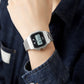 Silver digital sports watch on wrist with square resin case and metal link bracelet