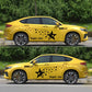 Black star pattern car decal set on yellow car doors and side skirts, 2 pieces.