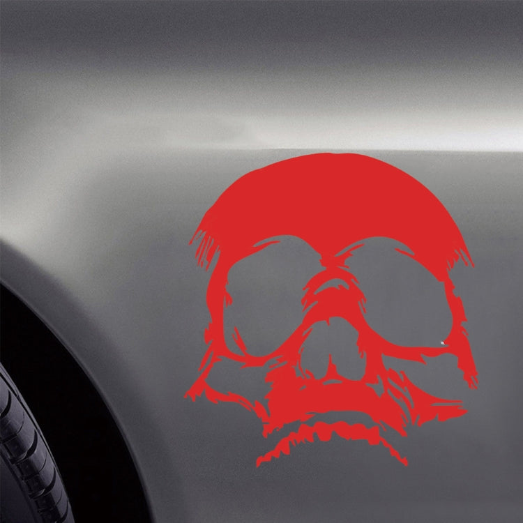 Red evil skull decorative sticker on vehicle hood with white facial highlights.