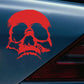 Red evil skull decorative sticker on car fender with white facial highlights.