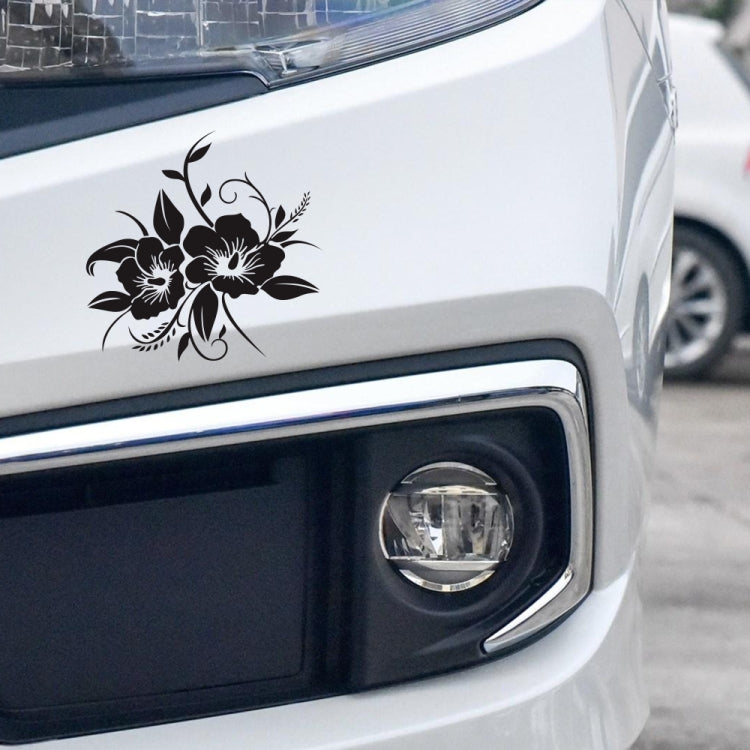 Black floral bloom car sticker on front bumper near headlight