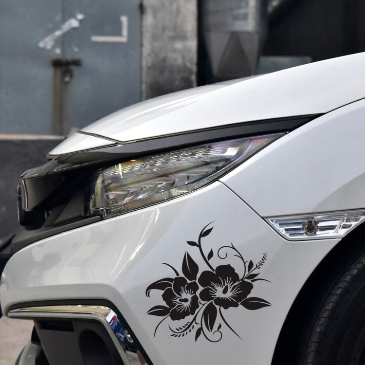 Black floral bloom car sticker on car fender near headlight
