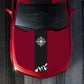 Compass sticker panel on red car hood: black vertical strip with white compass and mountain graphic.