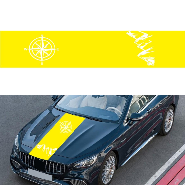 Yellow compass pattern decorative sticker with white compass rose and jagged graphic on car hood.