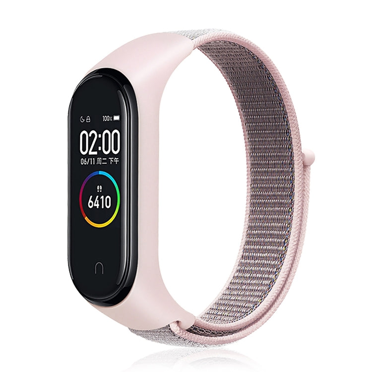 Nylon weave watch band with pink-gray strap for fitness tracker, blue display case.