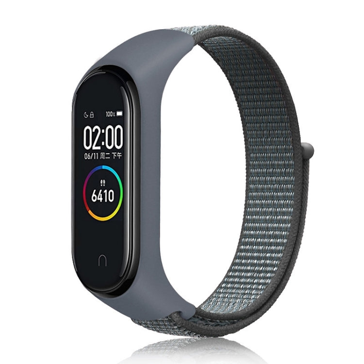 Nylon weave watch band with dark gray strap for fitness tracker, slate-gray display case.