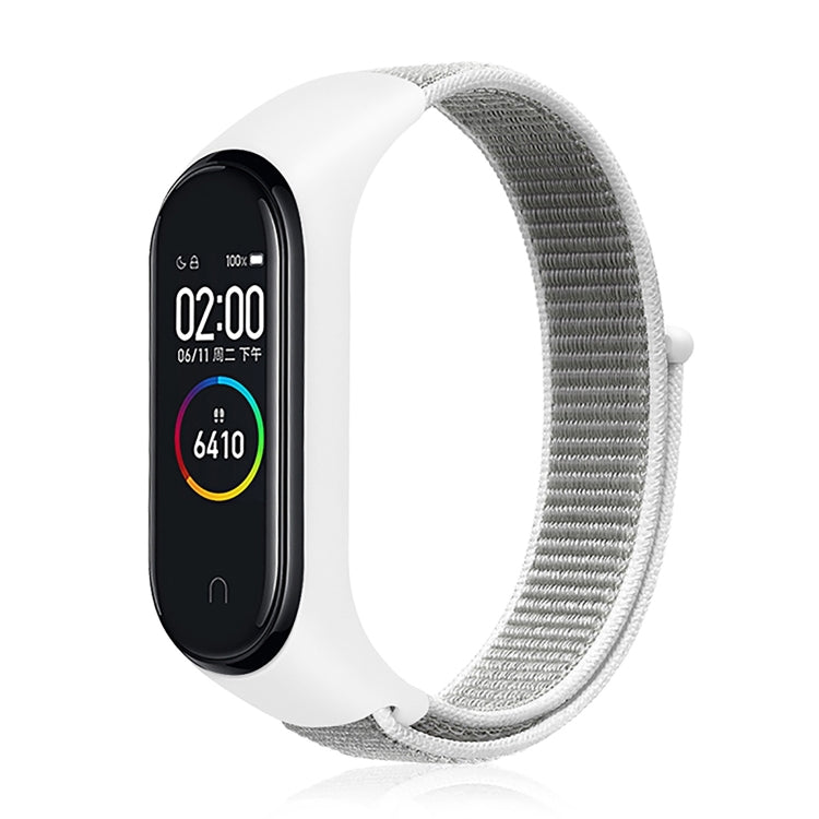 Nylon weave watch band with white strap for fitness tracker, silver-gray display case.