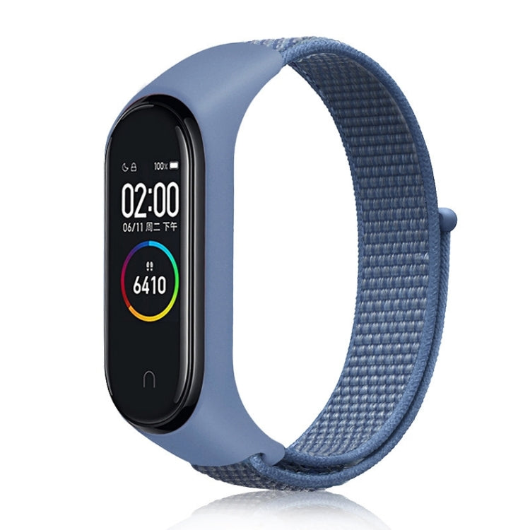Nylon weave watch band with blue denim strap for fitness tracker, blue display case.