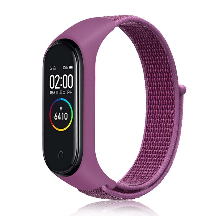 Nylon weave watch band with purple-magenta strap for fitness tracker, purple display case.