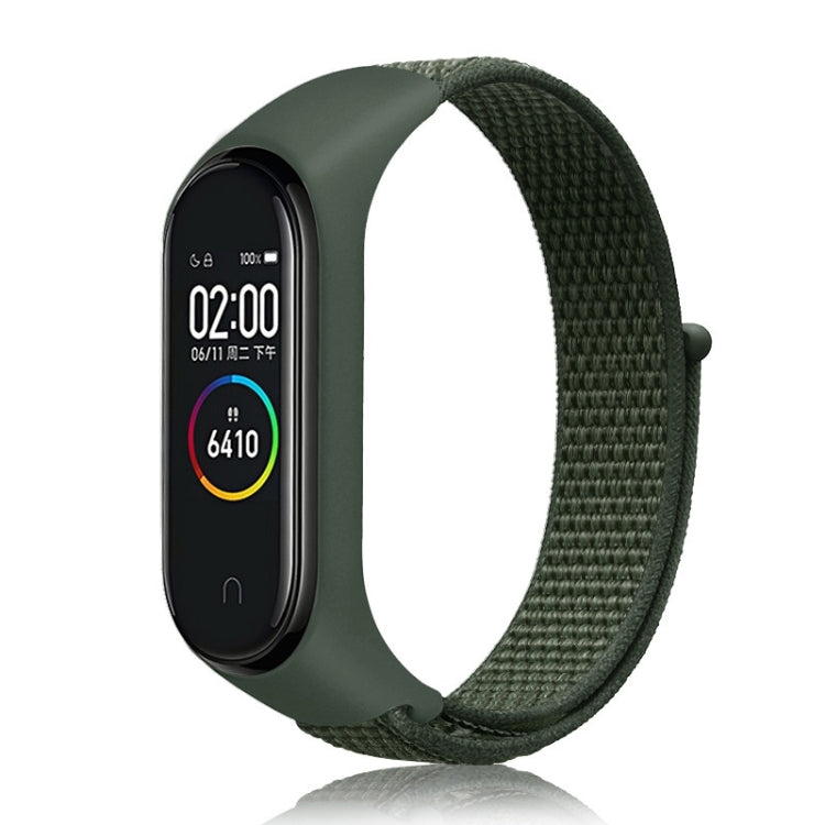 Nylon weave watch band with dark green strap for fitness tracker, olive display case.