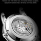 Mechanical watch case back with see-through movement window on a leather strap.