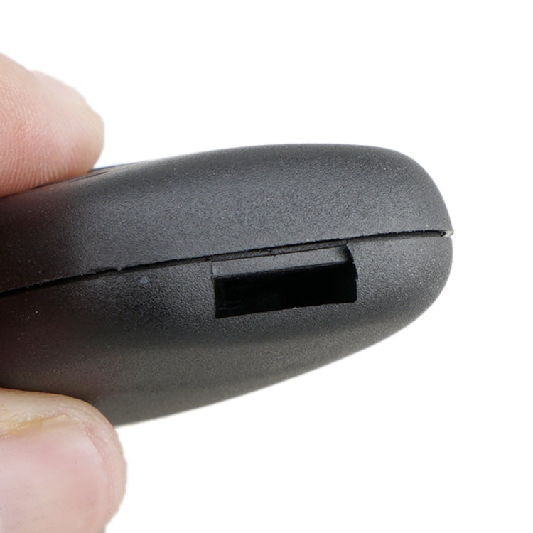 Car key remote shell close-up, dark gray plastic seam and opening