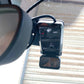 Single camera dash cam close-up with front lens and mounting clip inside vehicle