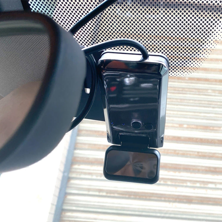 Single camera dash cam close-up with front lens and mounting clip inside vehicle
