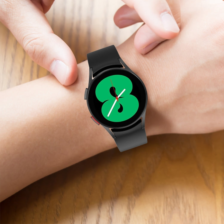 Black silicone watch band on wrist, with clasp and perforated strap holes