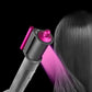 Dyson Airwrap anti-flying wind nozzle directing airflow toward hair, pink cap
