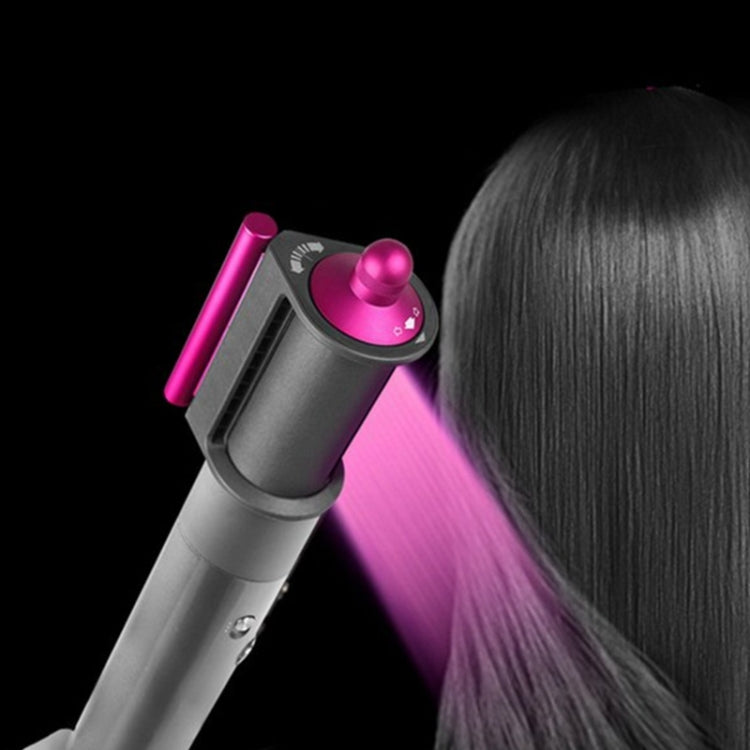Dyson Airwrap anti-flying wind nozzle directing airflow toward hair, pink cap