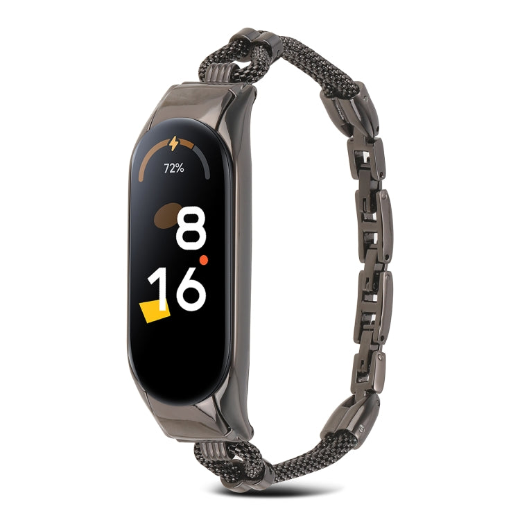 Black metal watch band with mesh links and rectangular smartwatch tracker, front view.