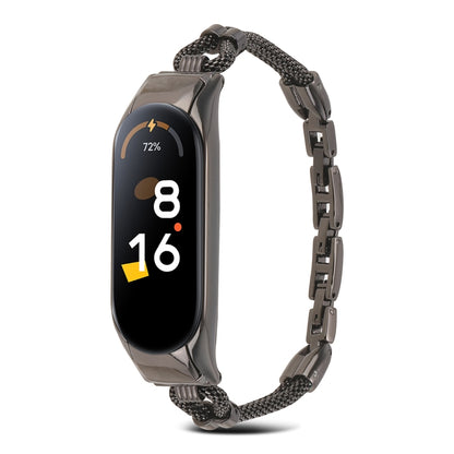 Black metal watch band with mesh links and rectangular smartwatch tracker, front view.