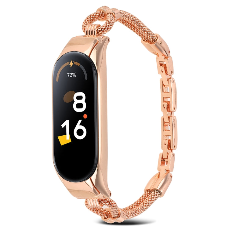 Rose gold metal watch band with mesh links and rectangular smartwatch tracker, front view.
