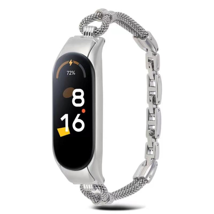 Silver metal watch band with mesh links and rectangular smartwatch tracker, front view.