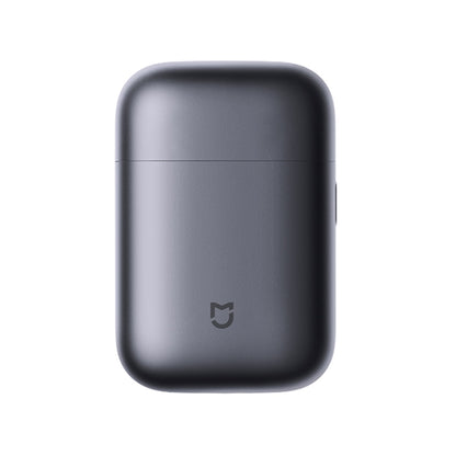 Electric shaver with dark gray rounded body and small power symbol on the front