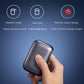Electric shaver in dark finish held in hand, rounded compact body design