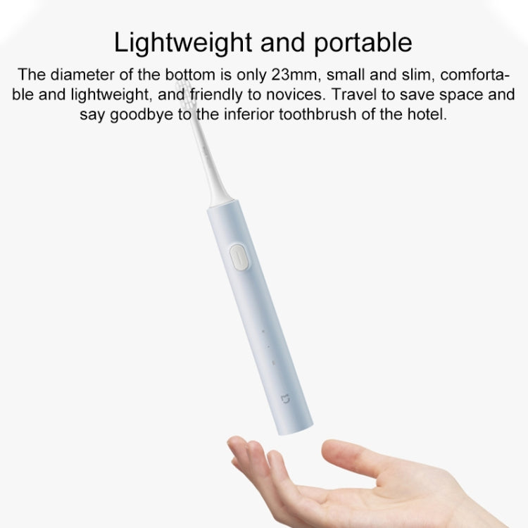 Electric toothbrush handle with white body and blue grip, control button on handle
