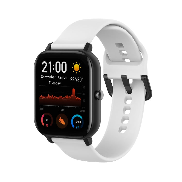 White soft silicone smartwatch band with adjustable holes and clasp.