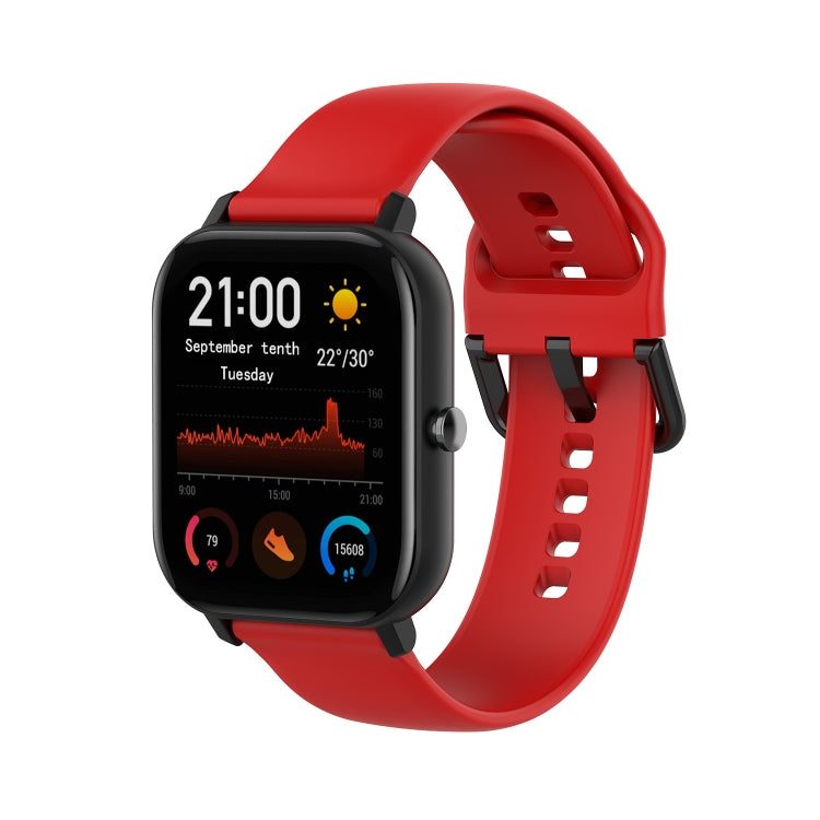 Red soft silicone smartwatch band with adjustable holes and clasp.