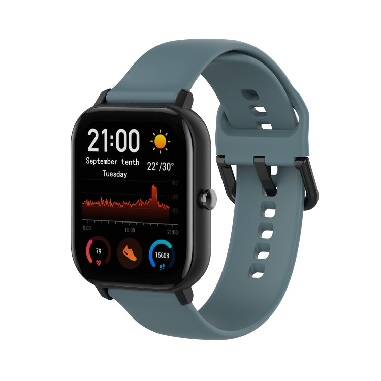 Steel blue soft silicone smartwatch band with adjustable holes and clasp.