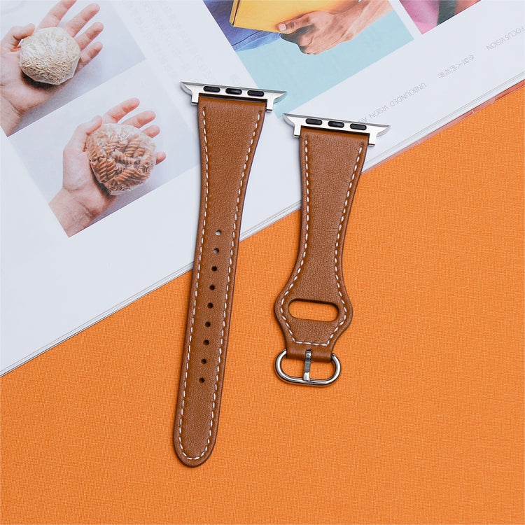 Two brown leather Apple Watch bands with silver buckles and white stitching