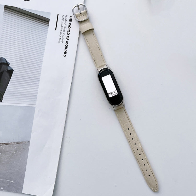 White genuine leather watch band with silver buckle and black smartwatch face