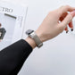 Beige genuine leather watch band with silver clasp on a wrist