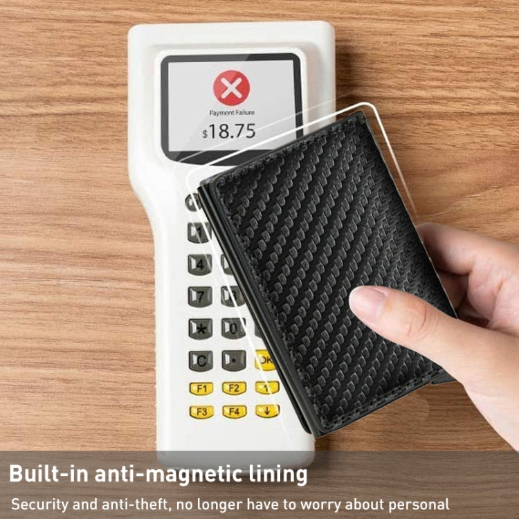 Black carbon fiber RFID wallet with anti-magnetic lining, held in hand