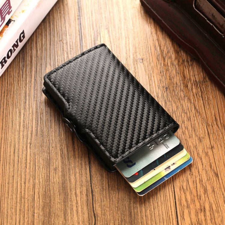 Black carbon-fiber RFID card holder with metal buckle, cards visible inside