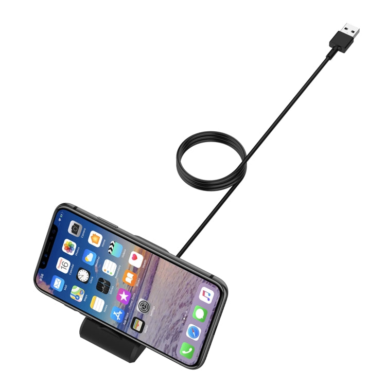 Black vertical magnetic charging stand holding a smartphone with USB cable