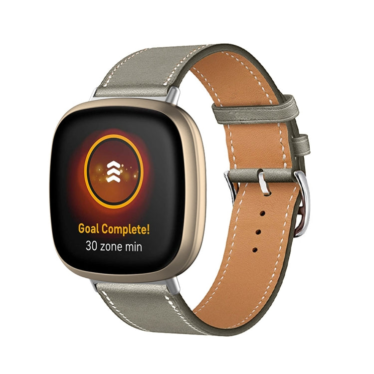 Grey leather watch band with brown underside, metal pin and perforations