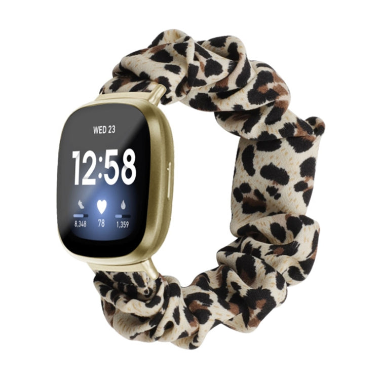 Leopard print cloth watch band with beige and black spots; smartwatch shown.