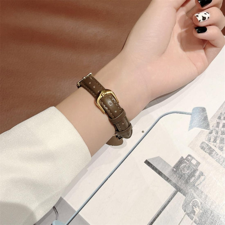 Brown genuine leather watch band with gold-tone steel D clasp on wrist