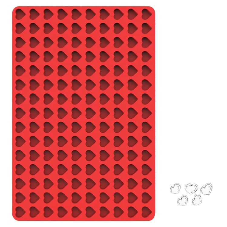 Red silicone cookie mould with heart-shaped cavities