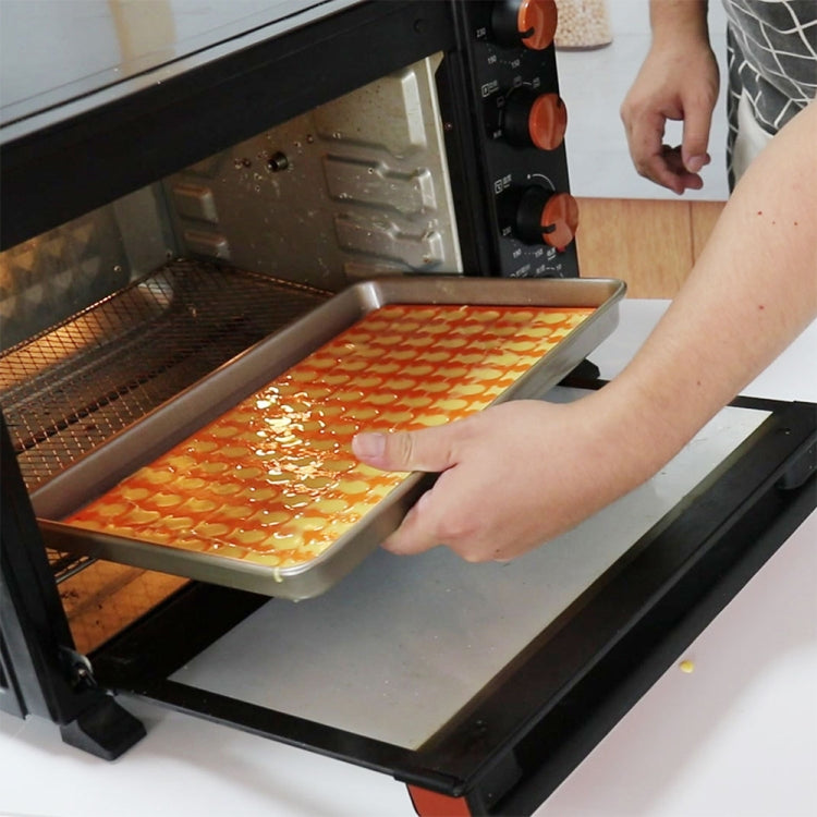 Orange silicone baking mould with cartoon animal cookie shapes in a tray