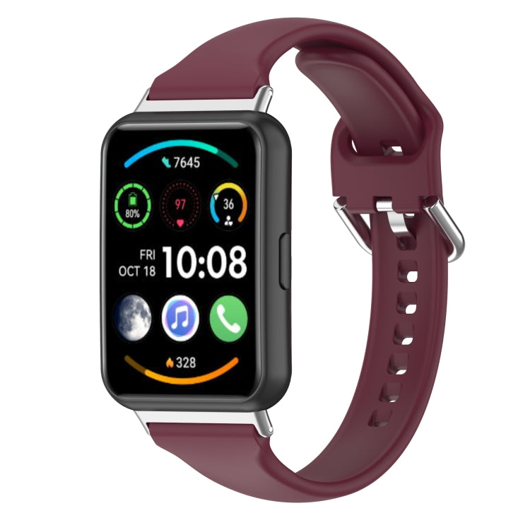 Burgundy silicone watch band shown with the watch face and side clasp.
