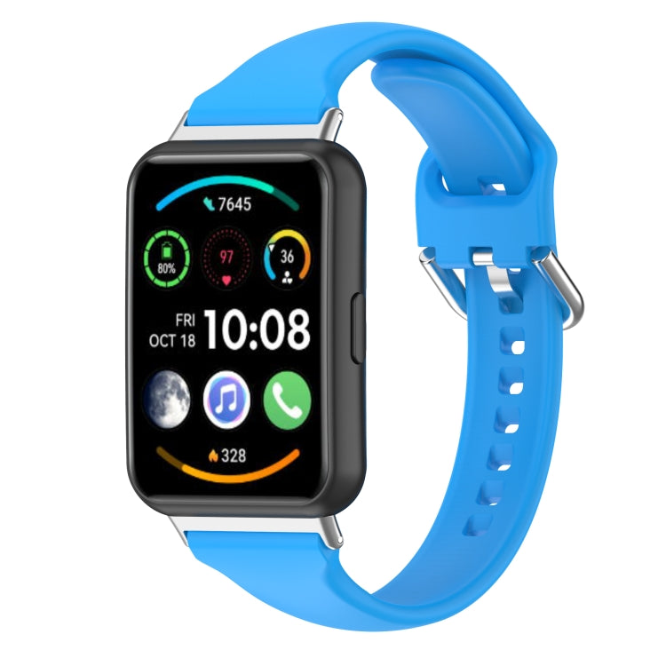 Bright blue silicone watch band with metal clasp and perforated strap holes.