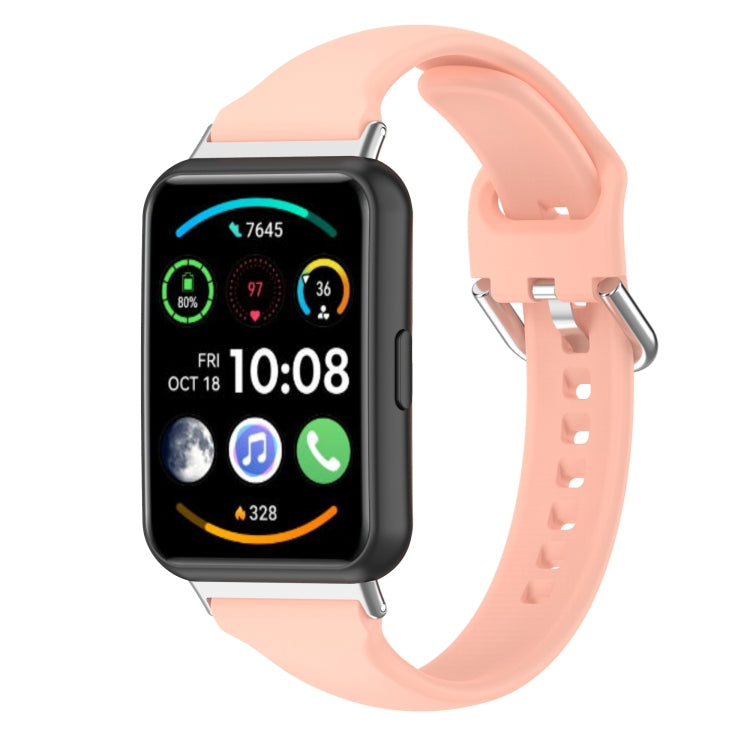 Silicone smartwatch band with metal buckle, light pink strap and perforated holes.