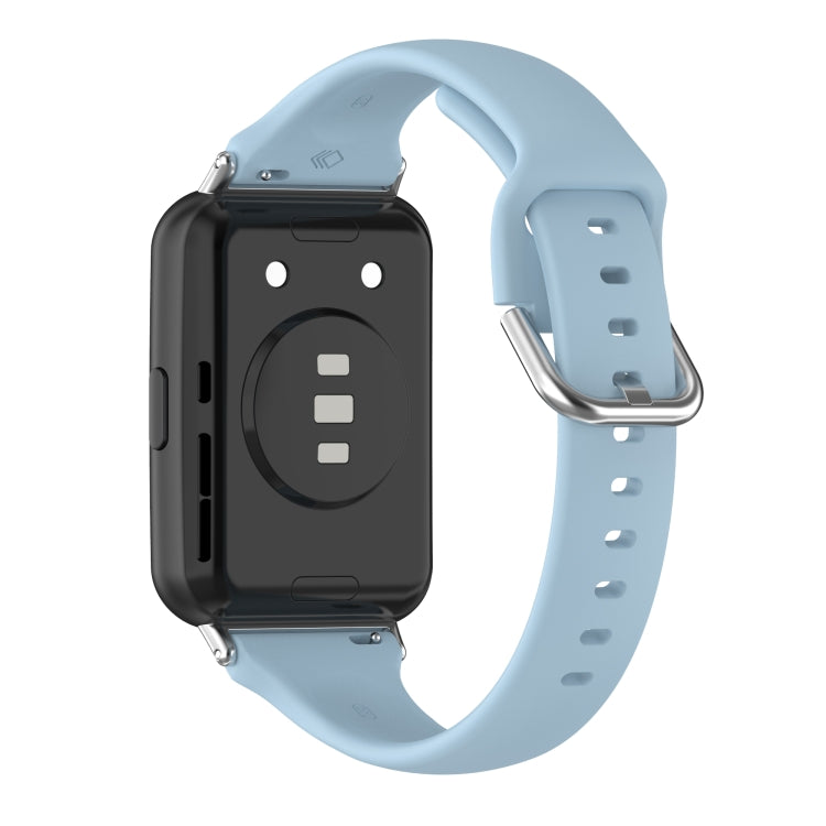 Silicone smartwatch band with metal buckle, light blue strap, clasp and underside shown.