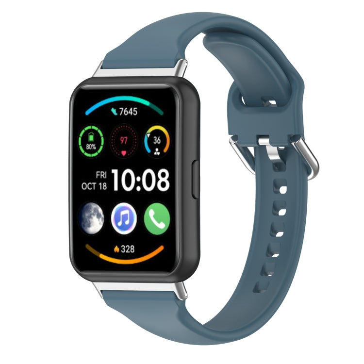 Silicone smartwatch band with metal buckle, slate blue strap and perforated holes.